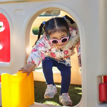 Little girl playing in a playhouse at Chandragiri Amusement Park