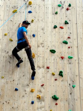 Man climbing an artificial wall at Chandragiri Amusement Park