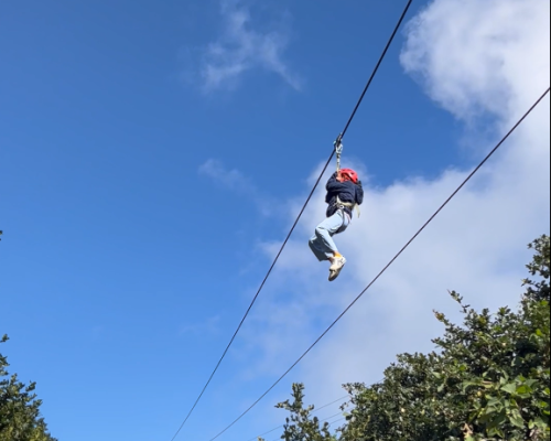 Person enjoying zipline at Chandragiri Hills adventure park