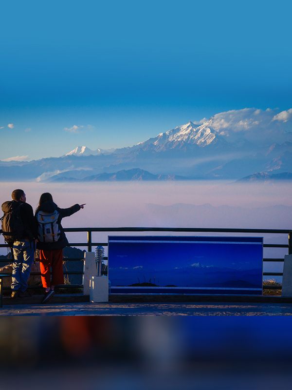Tourists enjoying panoramic Himalayan views from view tower at Chandragiri Hills
